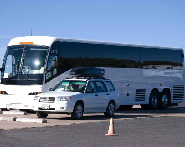 Subaru and tour bus